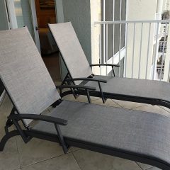 Two chaise lounge chairs on balcony