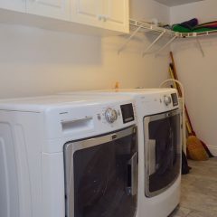 Full sized washer and dryer in laundry room