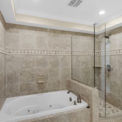 Master bath with spa tub and walk-in shower